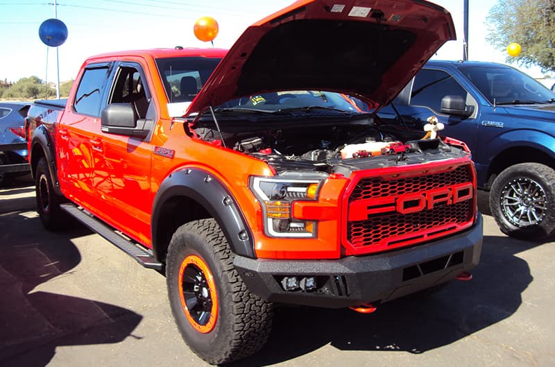 Red Ford Raptor with hood open