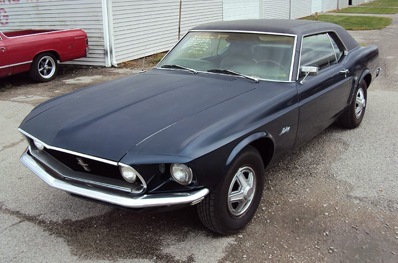 1970 Mustang in black with faded paint