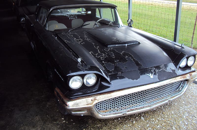 1955 Ford thunderbird in black with flaking paint