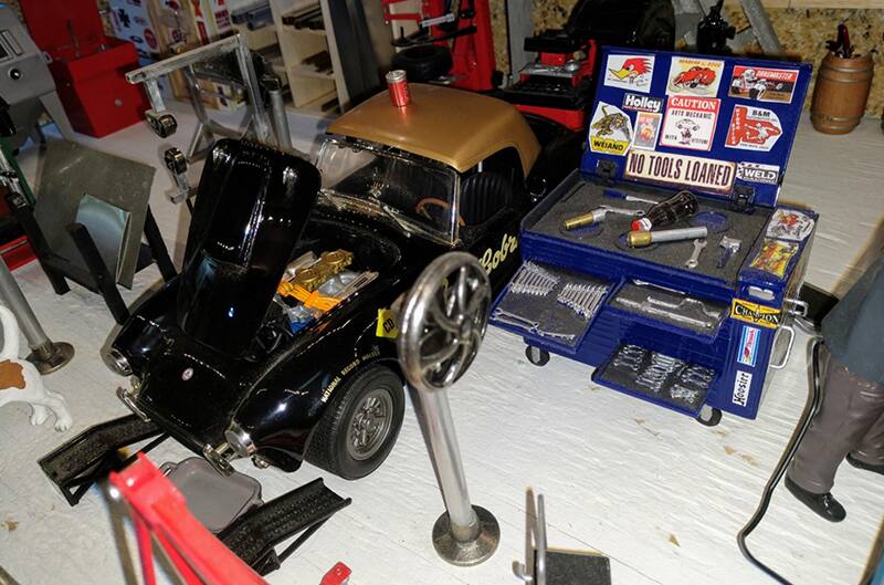 Black Shelby Cobra in the shop for upgrades