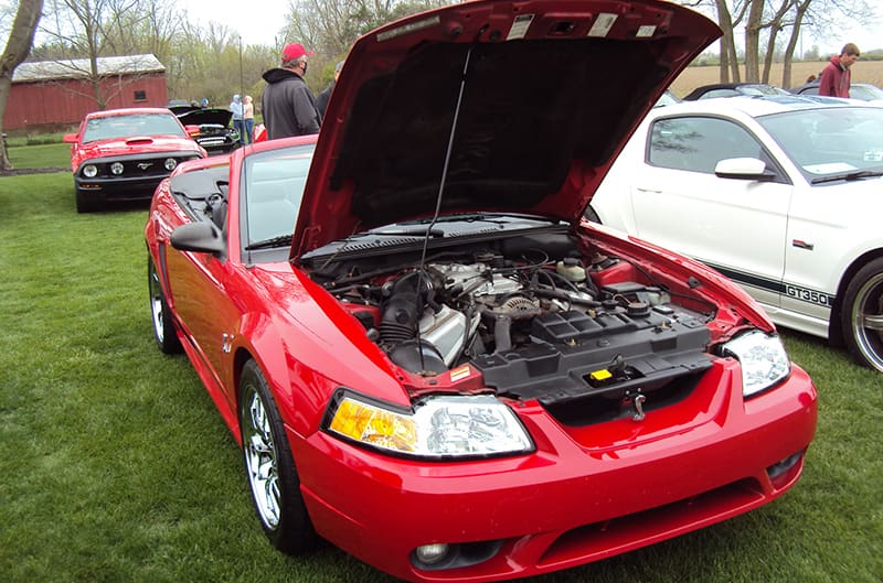 Red 1999 Ford Mustang Cobra with hood open