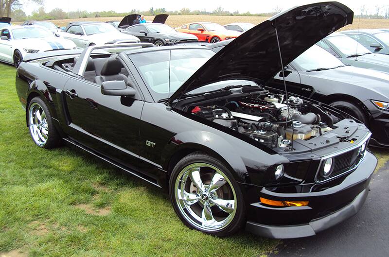 Black S197 Mustang with hood open convertible