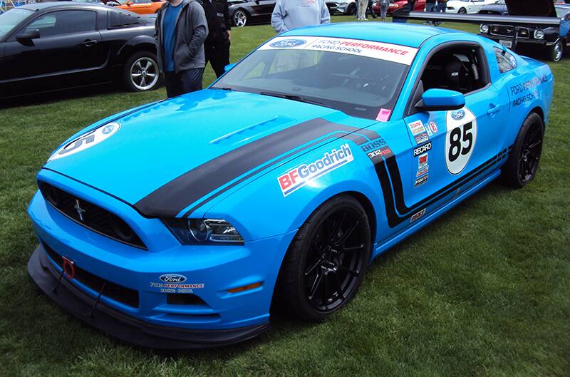 Grabber Blue S917 Mustang with many decals on side of car