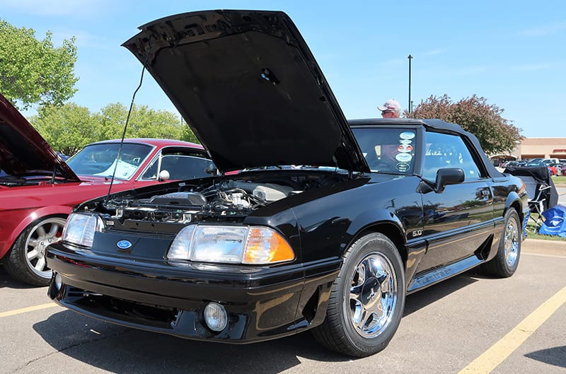 Black Foxbody mustang with chrome wheels in showfield