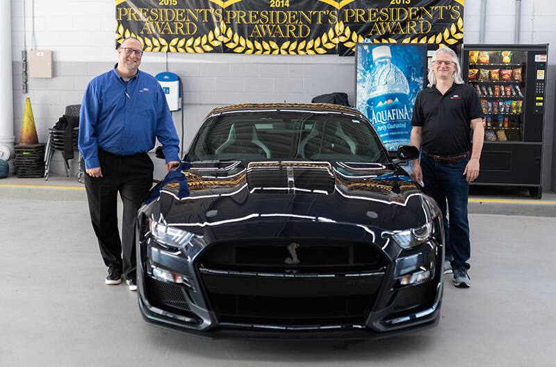 Widmann standing with Salesman Mike Rey and Shelby GT500