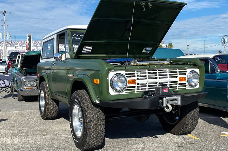 Green Ford Bronco with white grille