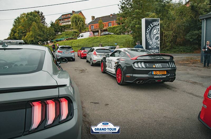 Ford mustangs driving into event