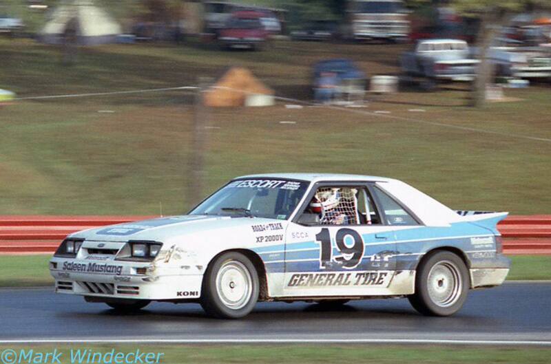 White Foxbody mustang on track at speed