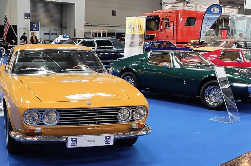 Orange and Green Ford capri's in convention center