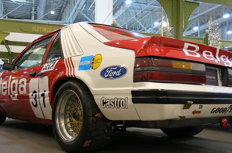 Red and white Ford foxbody Mustang racecar from rear