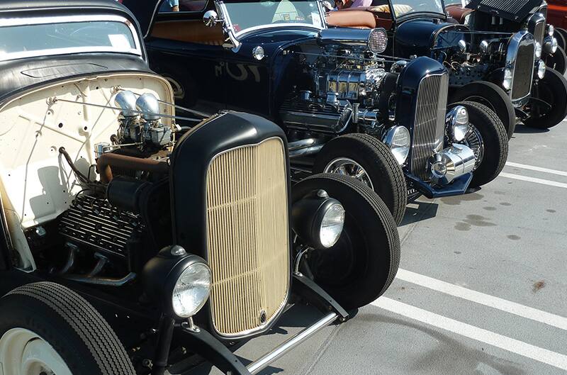 Black 1930s ford lined up in parking lot