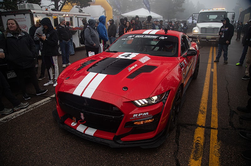 Red GT500 pulling up to start line