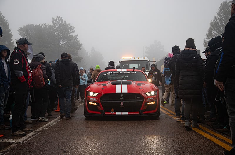GT500 approaching starting line with crowd around it