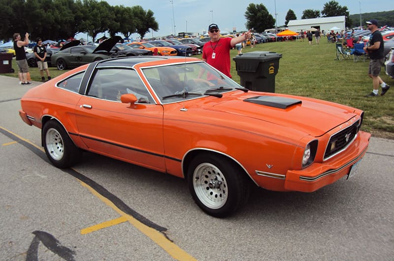 Orange Mustang II driving