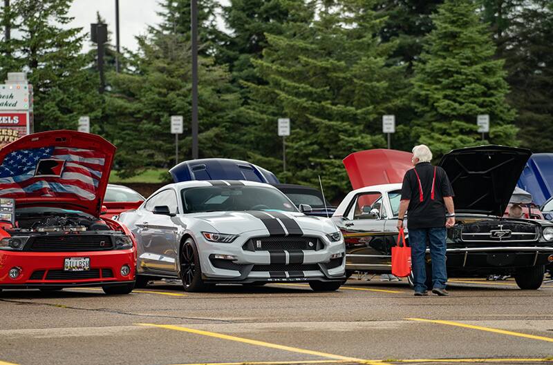 Several mustangs in AAA parking lot for show