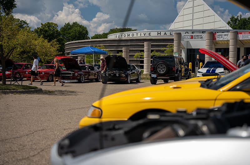 Auto hall of fame with mustangs in foreground