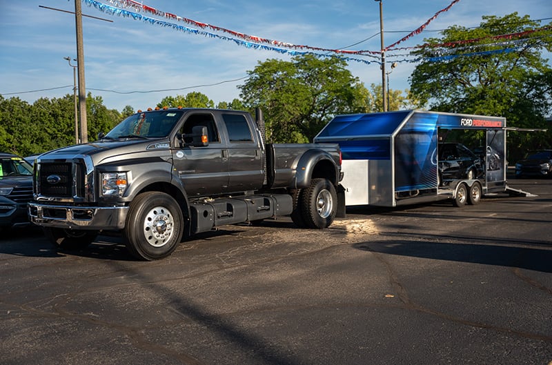 Ford F650 hauler with trailer behind it