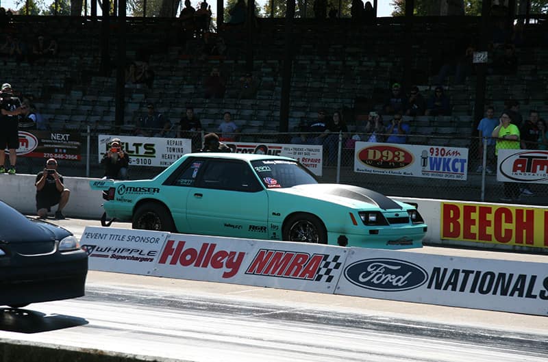 Teal foxbody mustang on dragstrip