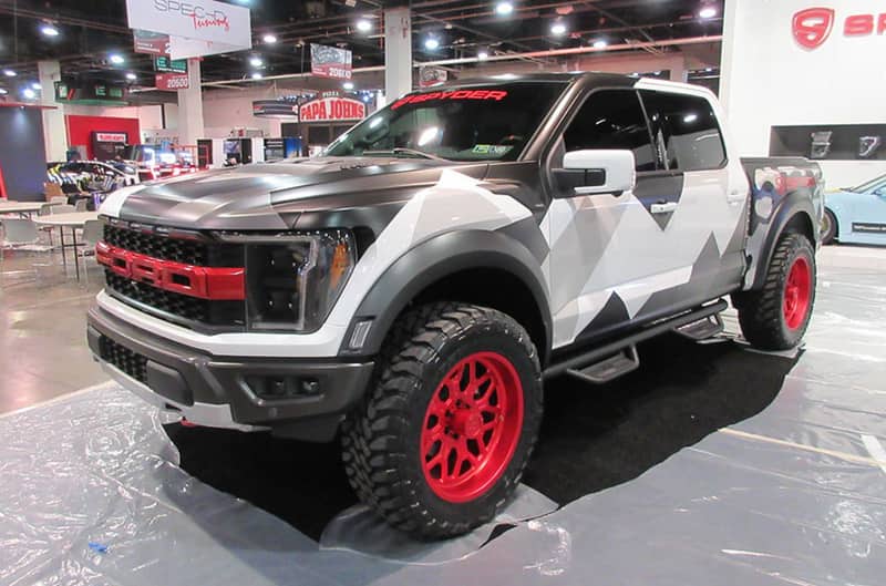 Gen 3 Raptor with camo wrap and red wheels