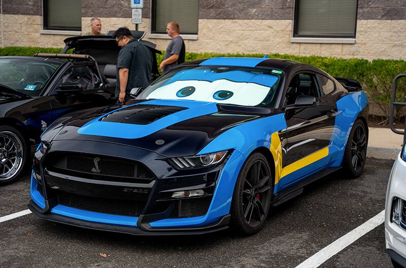 Multicolored GT500 Mustang at meet with eyes on windshield