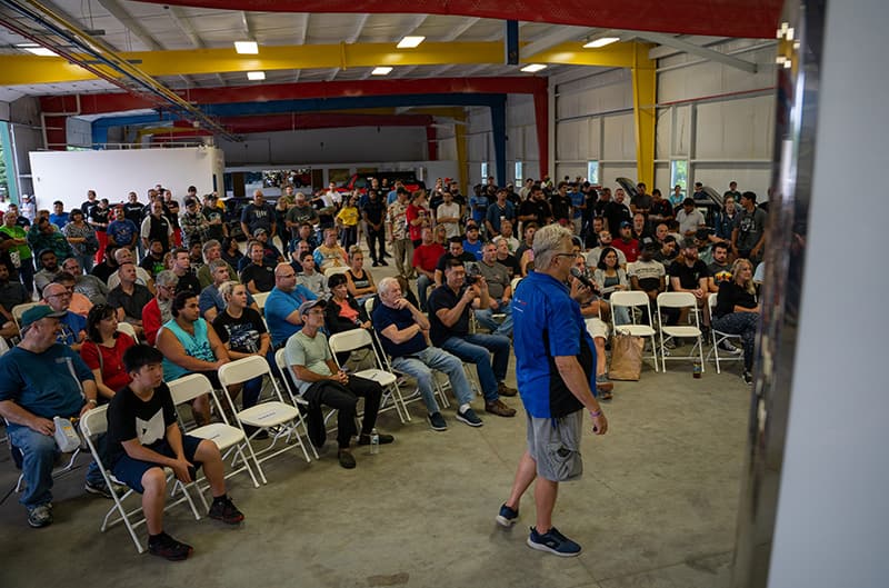 Audience inside shop listening to John Clor