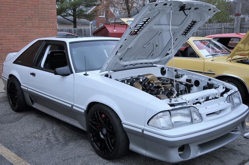 White foxbody mustang with hood open