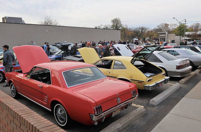 Several fords parked at Pasteiners with hoods open