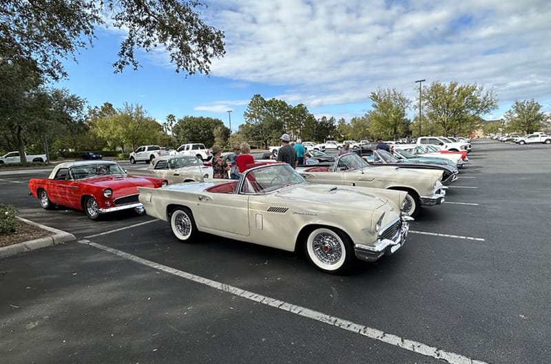 Several 1960s ford thunderbirds in parking lot