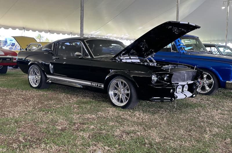 Black first generation Mustang with hood open