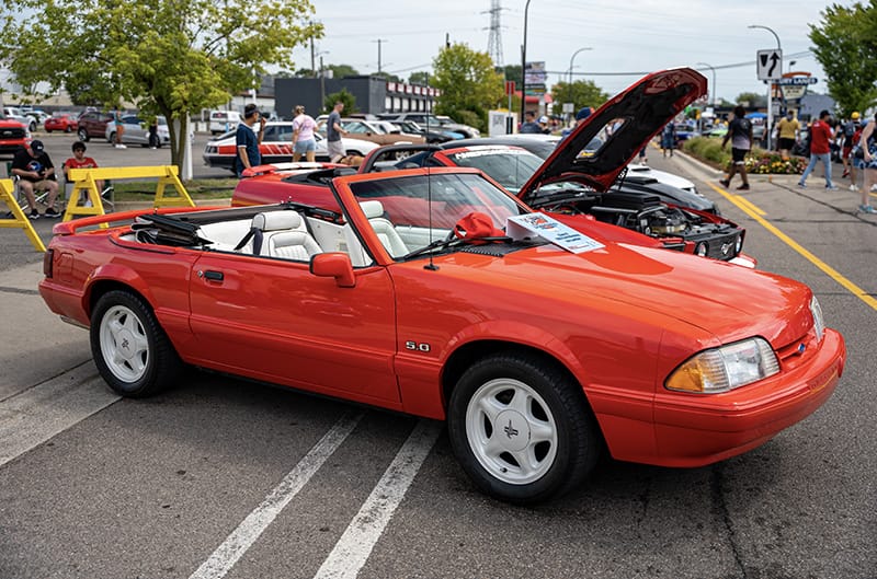 Red foxbody mustang convertible with white interior