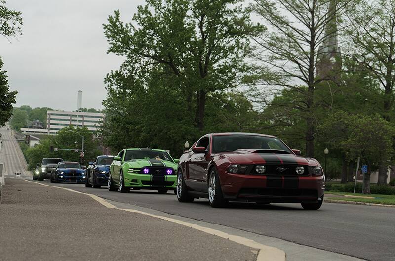 Mustangs driving into event