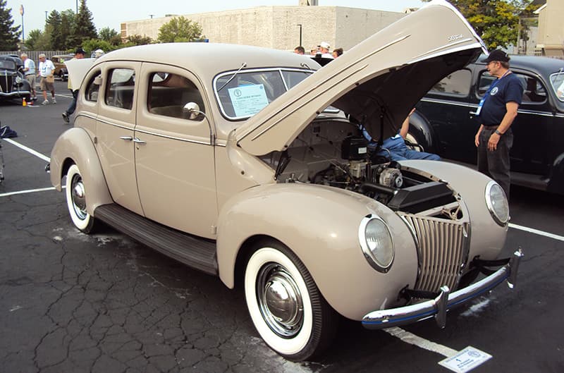 Tan Ford sedan with hood up