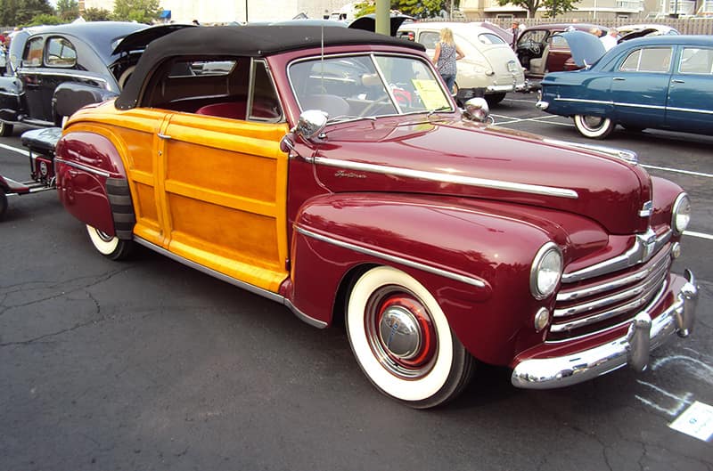 Red ford sedan convertible with wood siding