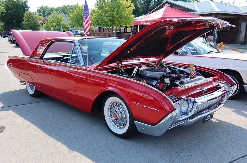 Red Ford thunderbird with hood open