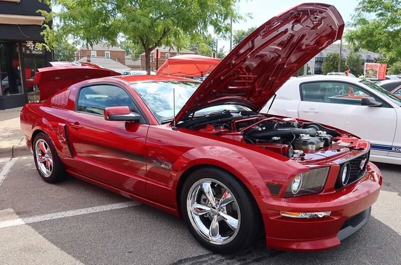 Red Ford Mustang S197 with hood open