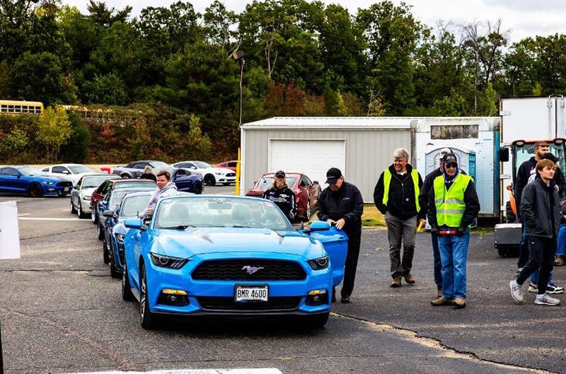 Mustangs in lines to enter car show