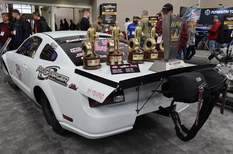 Mustang with large wing and trophies on the back