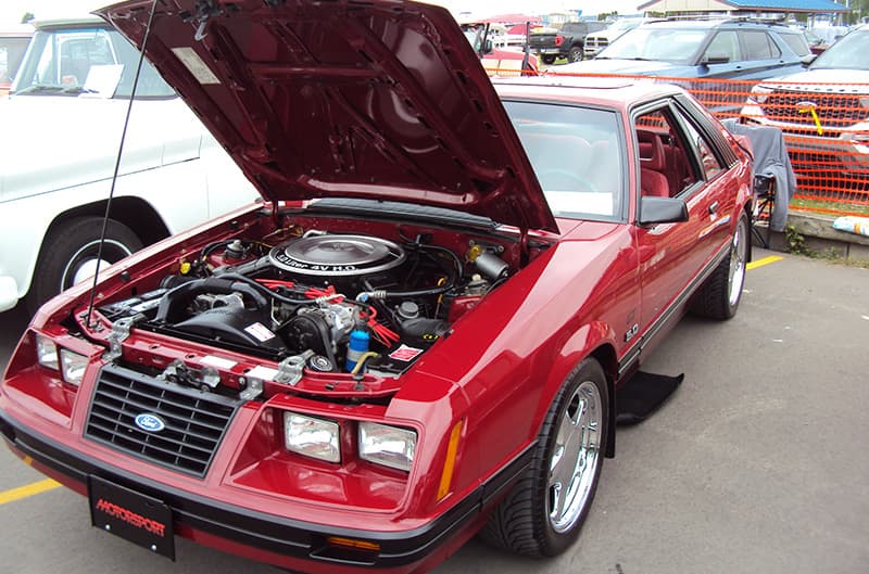 Red Foxbody mustang with hood open