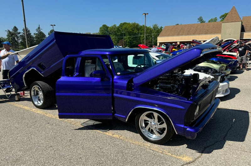 blue ford truck with hood open
