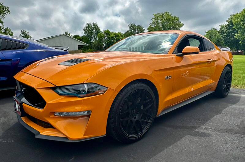 orange mustang in parking lot