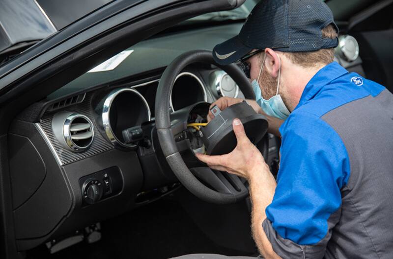 Technician replacing airbag in 2007 Mustang