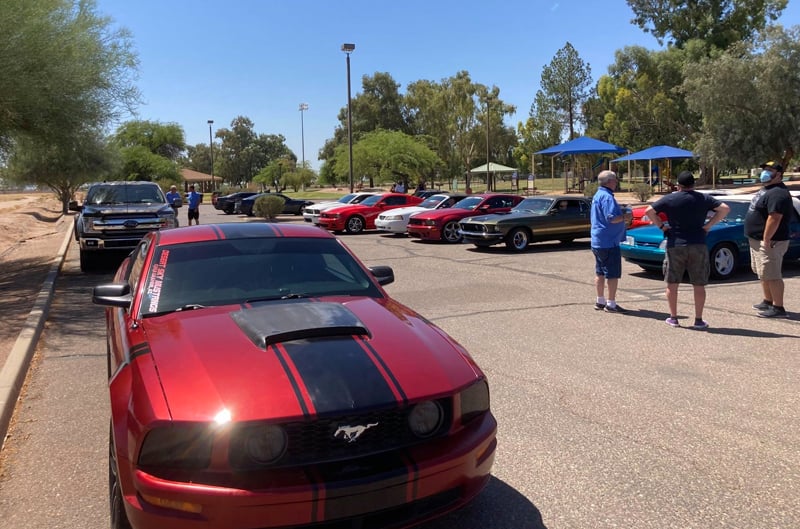 Red Mustang in parking lot car show
