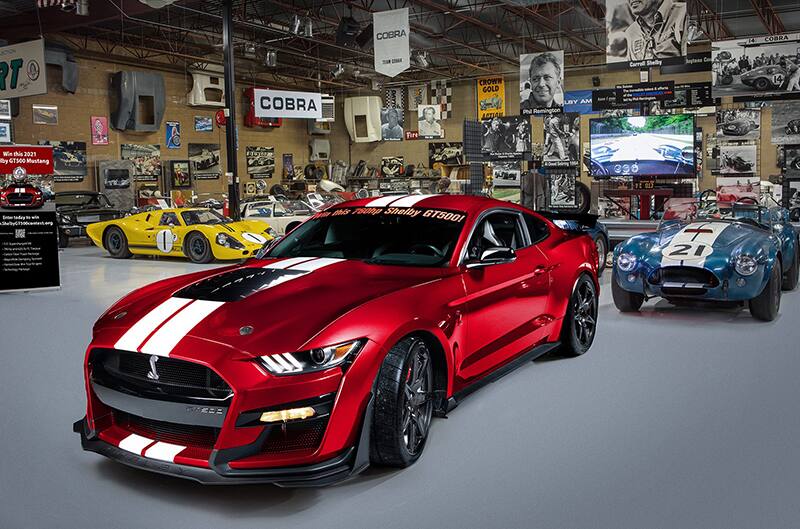 Red 2021 GT500 with Blue cobras to the left and right