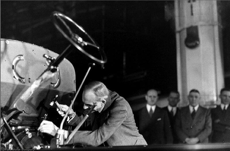 Henry Ford with vehicle at the unveiling of the Flathead V8 engine in 1932