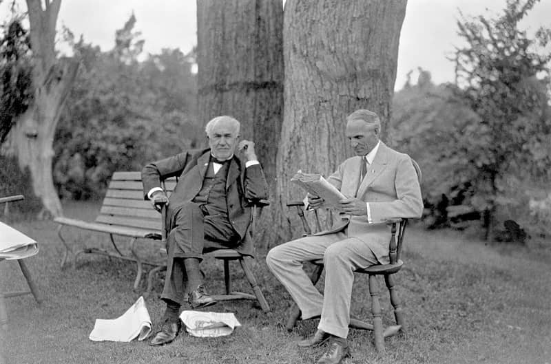 Henry Ford and Thomas Edison sitting outside