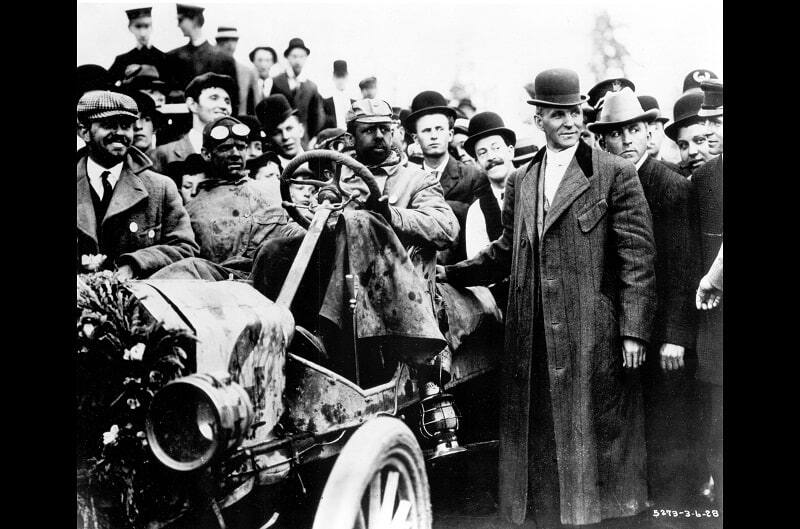 Men are pictured around a Ford car