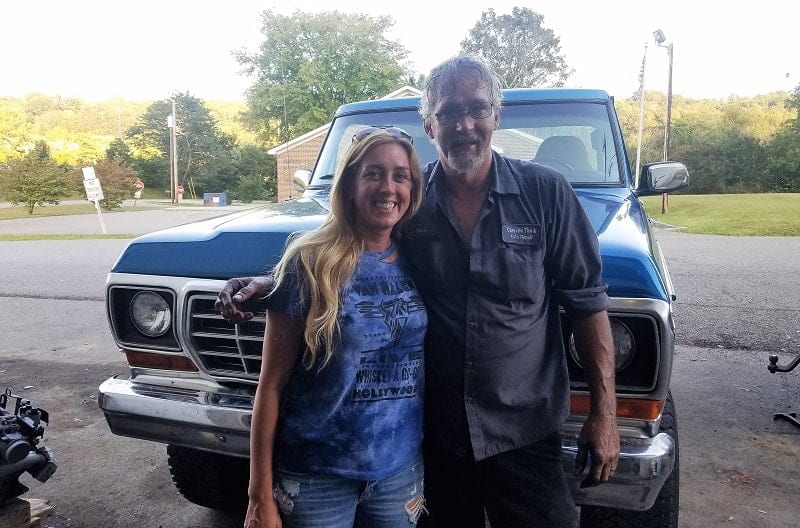 Courtney with mechanic in front of blue Bronco