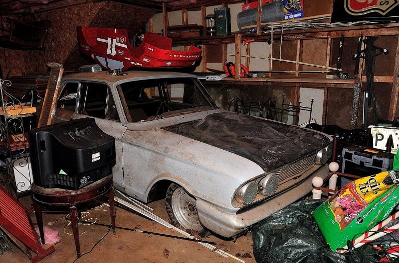 Rusted Bonner Thunderbolt inside garage with junk surrounding it