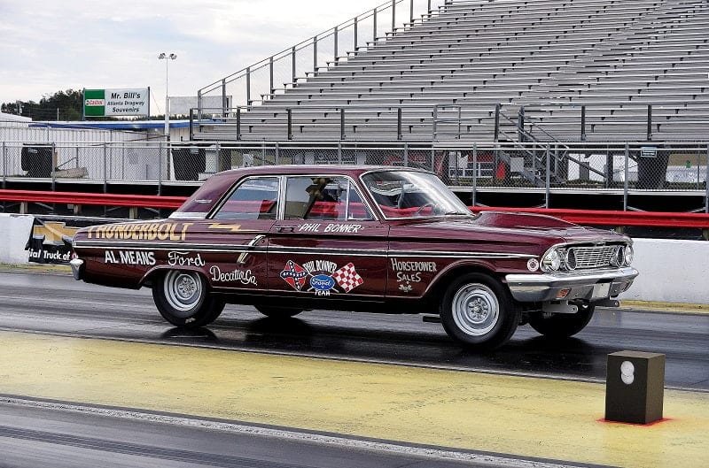 Red painted Bonner Thunderbolt on the track with 1960s reference pictures painted on