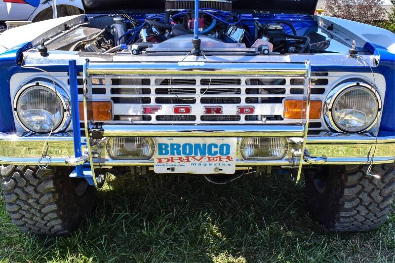 Close up front view of blue Bronco with hood up